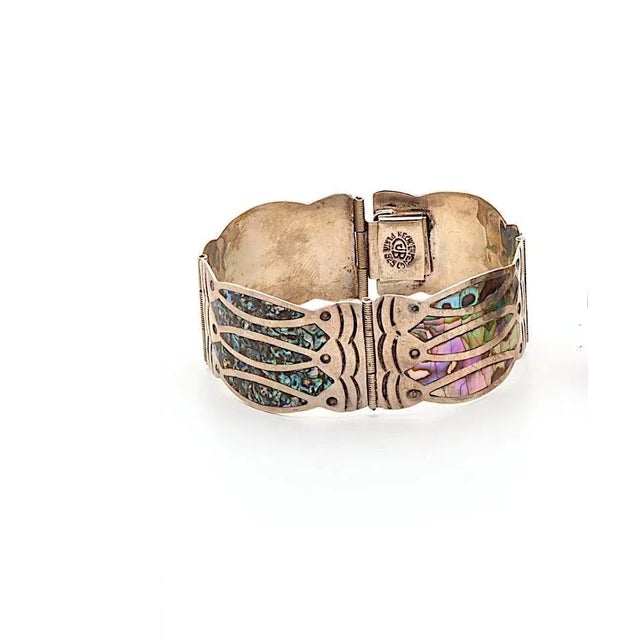 This is part of Chairish’s Costume Jewelry assortment. Featured is a Diaz Santoyo bracelet inlaid with abalone in a Fish...