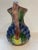 Vintage hand painted ceramic pottery pitcher. Lovely grape pattern with hand that resembles a grape vine. Measures 10"...