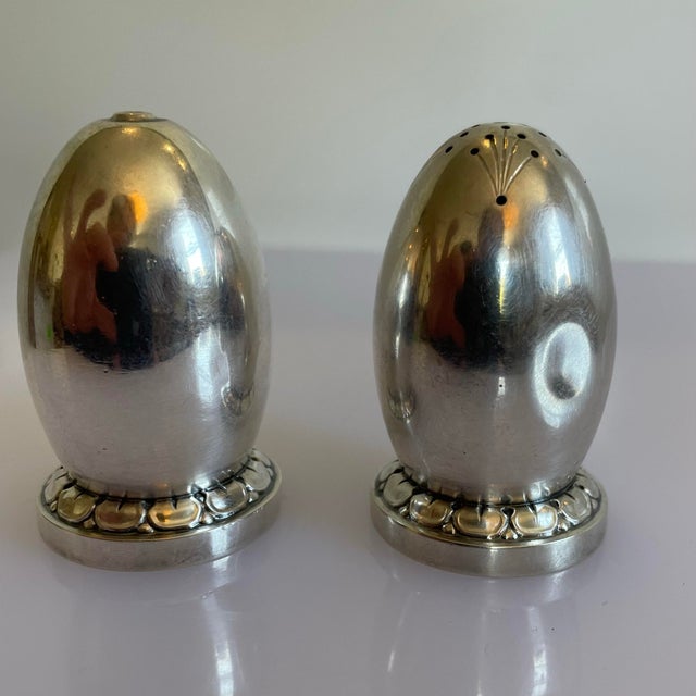 A pair of Danish mid century salt and pepper shakers. The set are in an egg shaped sterling silver.