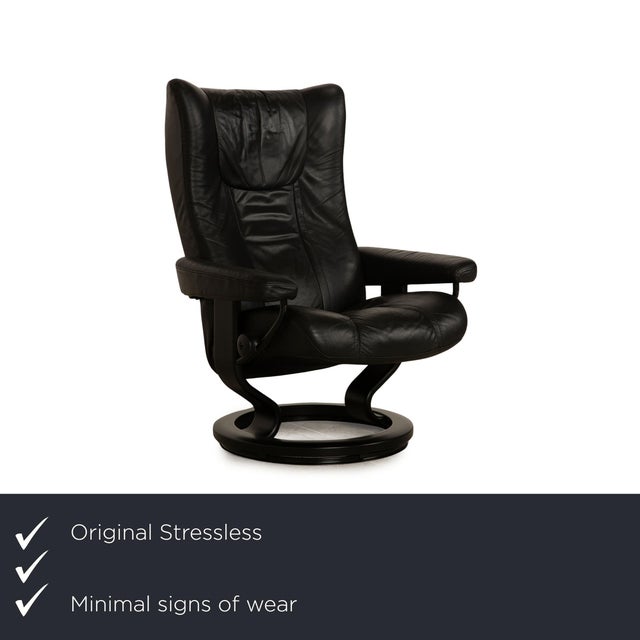 The Wing armchair from Stressless is covered with a black real leather and is on a round wooden foot. The practical side...