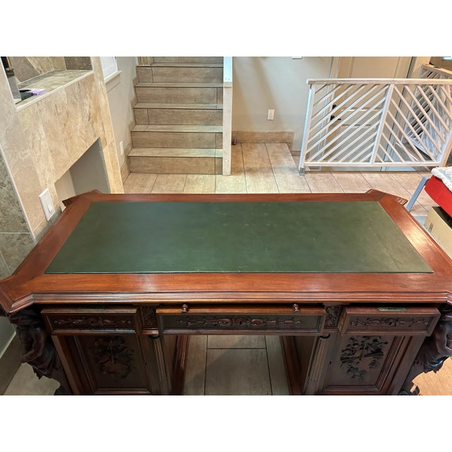 This impressive desk represents the height of late 19th-century Renaissance Revival craftsmanship, characterized by its...
