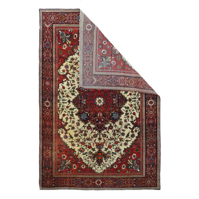 Antique Farahan Sarouk Rug 4'3'' x 6'4''. On an ecru field scattered with flowers and a structural vinery, is set a large...