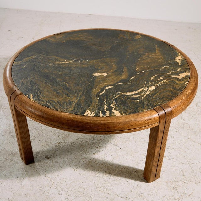 Round shaped coffee table with oak legs and artificial stone top from the 1980s. with some surface scratches, stains and...