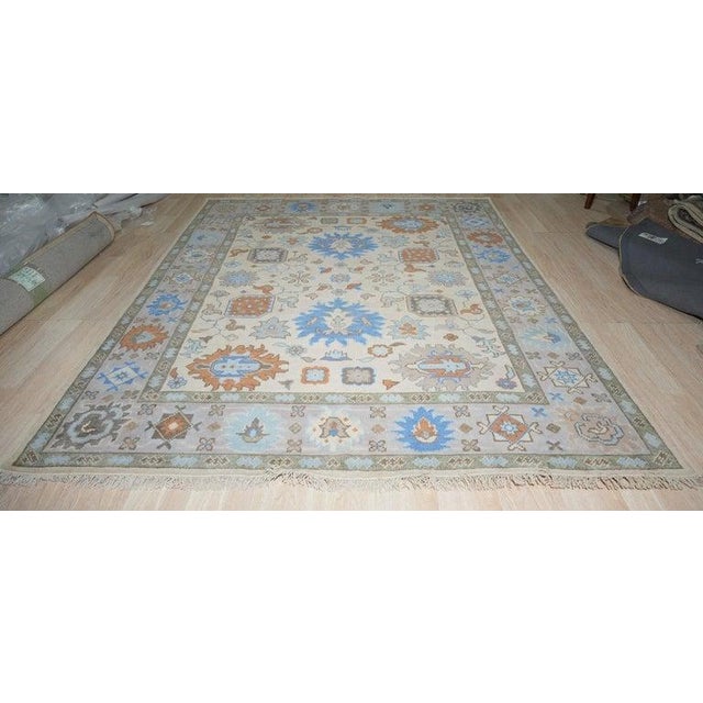 This hand knotted pile rug features a primary color palette of ivory, beige, cream, and white. Crafted from high-quality...