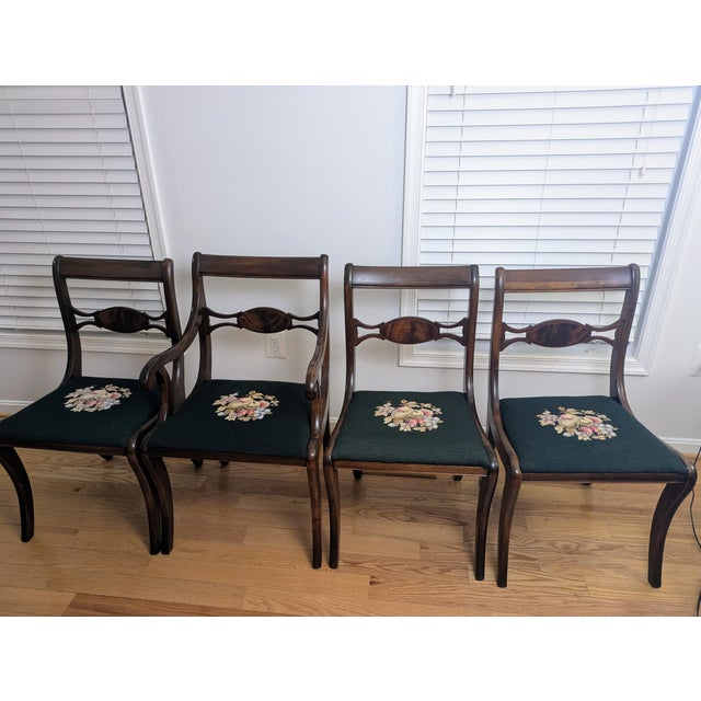 Elegant mid-century Duncan Phyfe / Federal–Regency revival dining chairs featuring rolled crest rails, a classic oval...