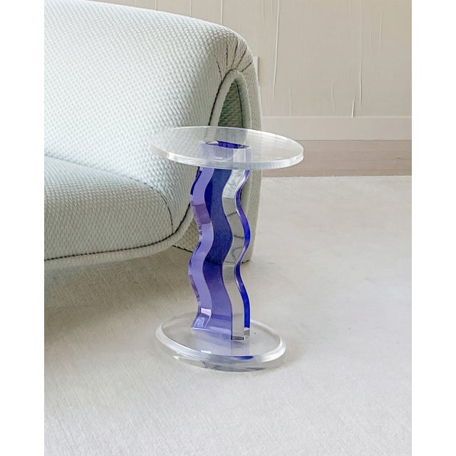 Haziza Lucite side table featuring a bold purple lightning bolt-shaped base with clear Lucite top and bottom. Iconic 1980s...