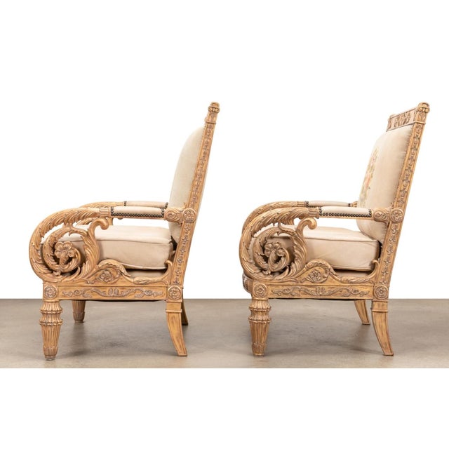 Neoclassical style gilt wood needlepoint arm chairs with leather upholstery, acanthus leaf scroll arms, raised on tapered...