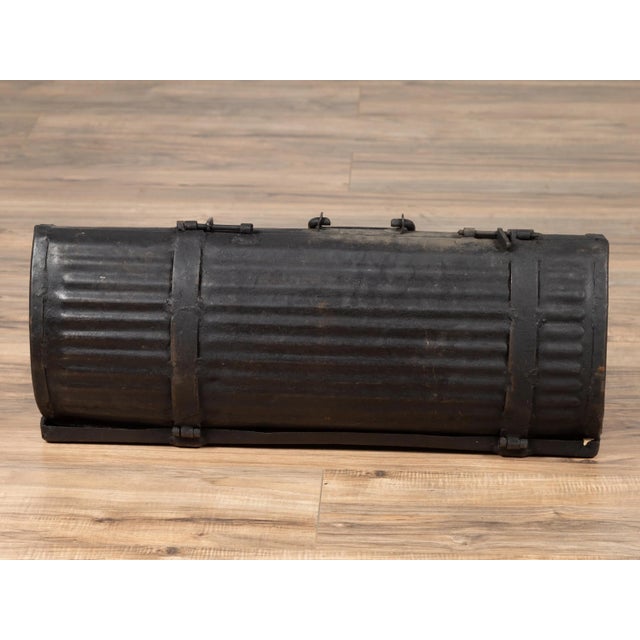 An antique rustic metal tool box from the early 20th century, found in India. Presenting a dark patina and ribbed surface,...