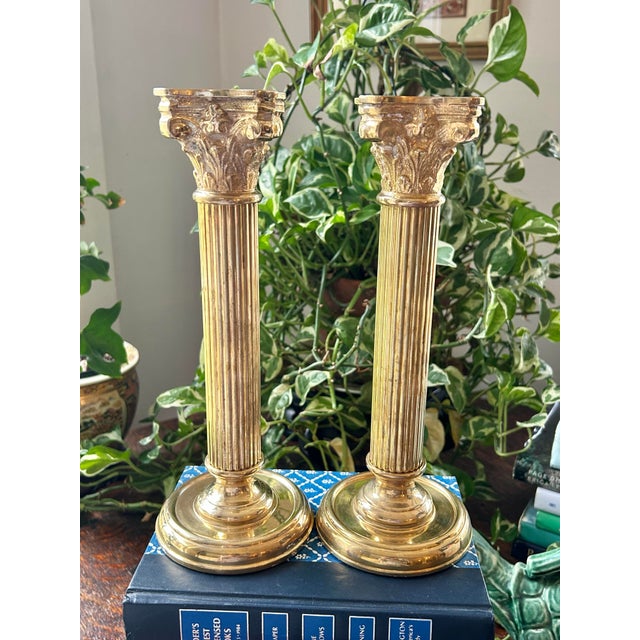 Styled as Corinthian columns, this pair of heavy brass candlestick holders are perfect for an entry table or mantel. From...