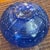 Mikasa "Cascade Blue" vase. It is characterized by its round, bulbous shape and intricate internal white swirl or...
