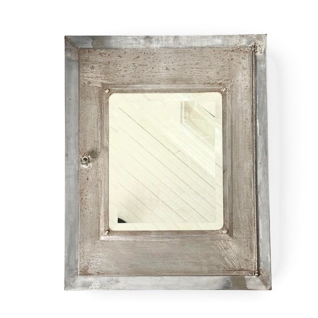 Vintage industrial steel medicine cabinet from the early 1900s. Beveled mirror. Wall hung. Sturdy condition. There is some...