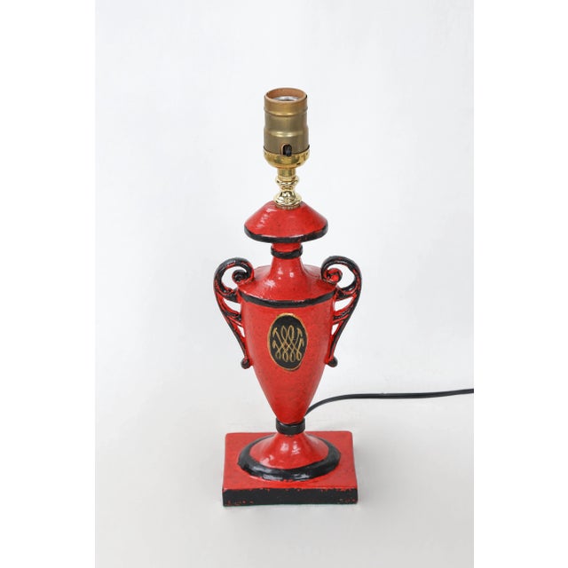 This urn lamp includes the lid as part of the lamp. Handpainted red with black and gold accents, and a cypher of the Duke...