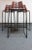 Set of three richly patinated barstools with leatherette seats supported by wrought iron and steel frames with footrests...