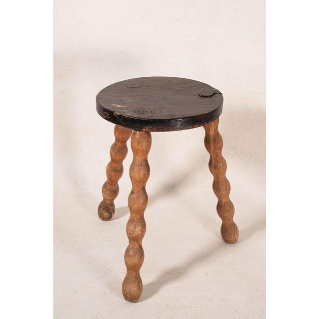 Antique two-toned bobbin joint stool with a rectangular plank top, turned bobbin legs, and box stretchers, showcasing...