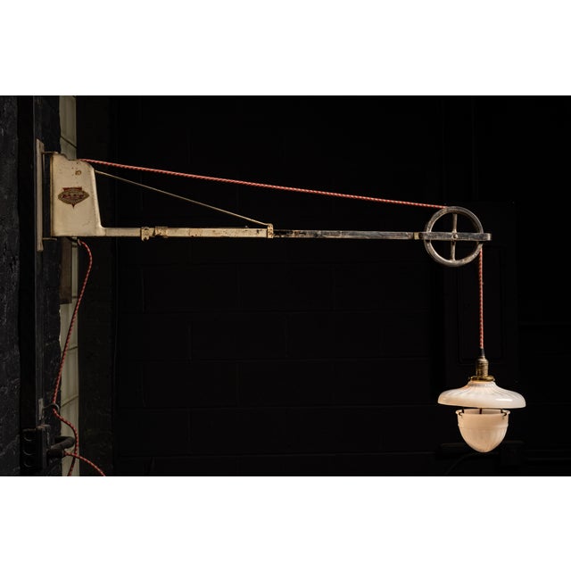 c. 1920s-1930s; Burdick Cabinet Company - Milton, WI Adjustable industrial wall lamp with pulley arm mechanism, fitted...