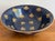 Beautiful 1990s hand-painted porcelain gold bee bowl with matte navy blue background. Made by Andrea by Sadek. For...