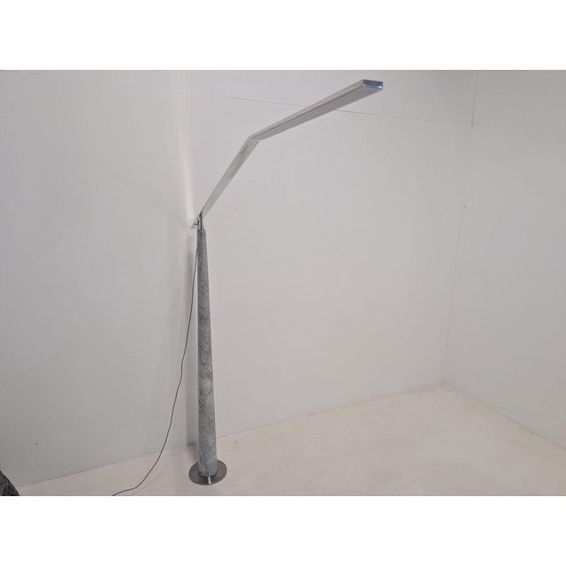 Floor lamp with dimmer and conical leg in bardiglio marble and base in stainless steel. Rotary upper part 360° in polished...