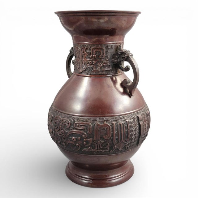 A large Japanese archaistic bronze hu vase from the Meiji–Taishō period, cast in bronze and finished with mechanical...