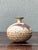 This handcrafted ceramic vase is a charming example of mid-century studio pottery, celebrated for its organic form and...