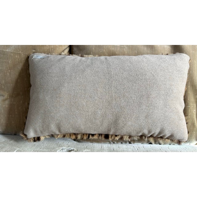 A lumbar pillow made from a genuine leopard hide backed with coordinating cashmere, a down insert is included.