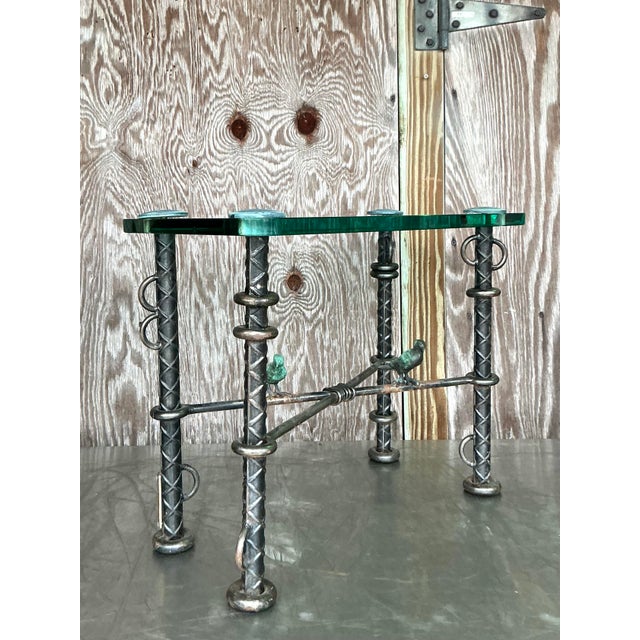 Stunning vintage Ilana Goor side table crafted from rebar with intricate sculpted bird accents. This rare statement piece...