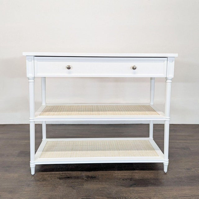 The table is defined by simple lines and classic detailing, with a panel front drawer and turned columns. This table has...