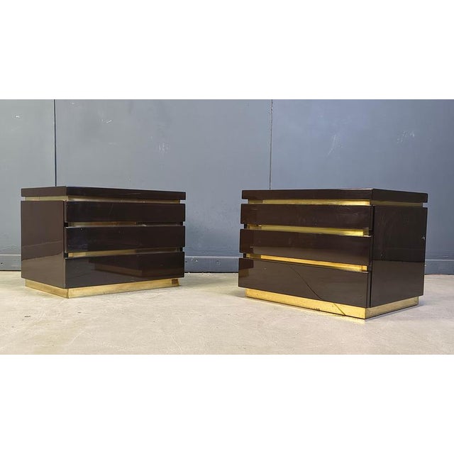 Pair of dark brown lacquered and brass bedside cabinets by Jean Claude Mahey. Jean Claude Mahey always meets the high...