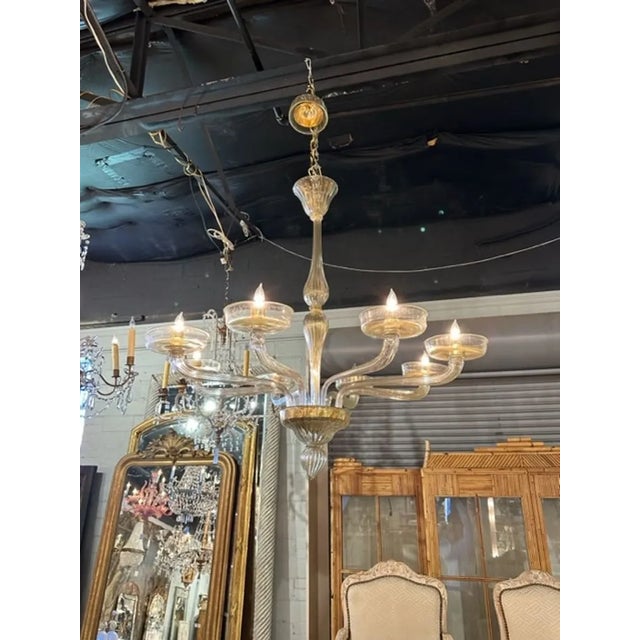 Modern Murano gold glass 8-arm chandelier. The chandelier has been professionally rewired, comes with matching chain and...
