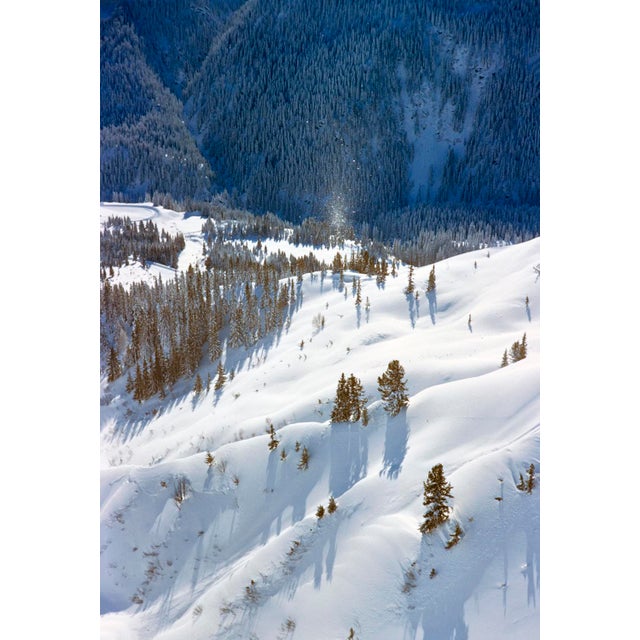 St Anton Snow by Toni Frissell Snow begins to fall on an already snow covered mountain side with pine forest behind it....