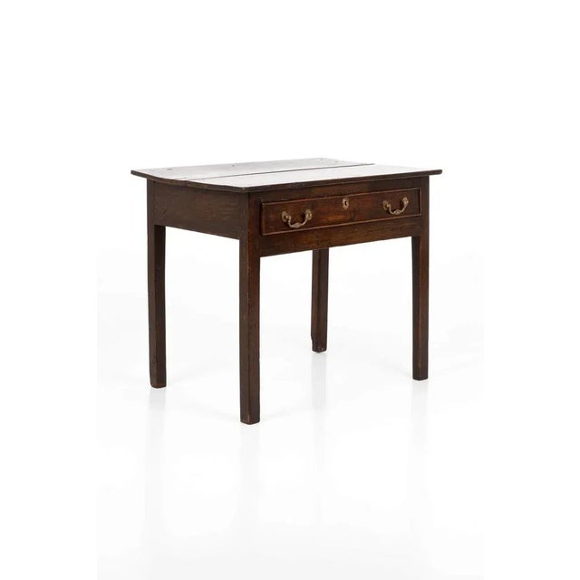 A wonderful 18th century oak side table with a single frieze drawer. Original brass swan drop handles with detailed brass...