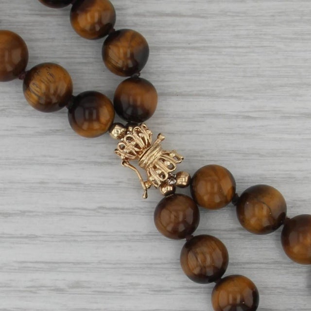 Gemstone Information: - Natural Tiger's Eye - Size - 10.2 - 12.2 mm Cut - Round Bead Shape Color - Bronze Brown Metal: 14k...