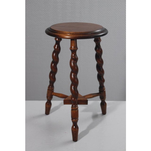 Mid-20th century tripod plant stand or stool in turned wood, in the style of Charles Dudouyt's designs. In very good...