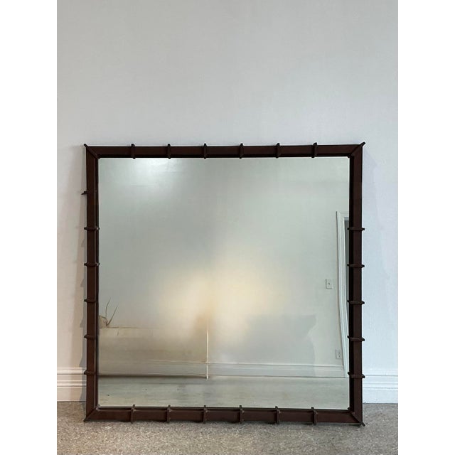 Elevate your interior with the bold, architectural presence of this vintage wrought iron wall mirror. Defined by its...