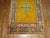 An early 20th century angora wool Oushak rug with a saffron gold colored ground on an open field and center medallion....