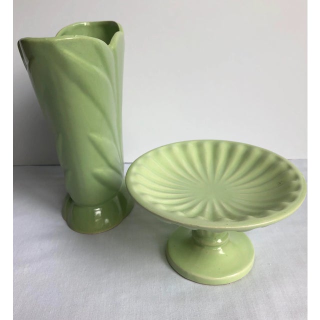 Two pieces of vintage USA pottery in a lovely pistachio color. The pedestal is marked “Hull.” The vase is slightly deeper...