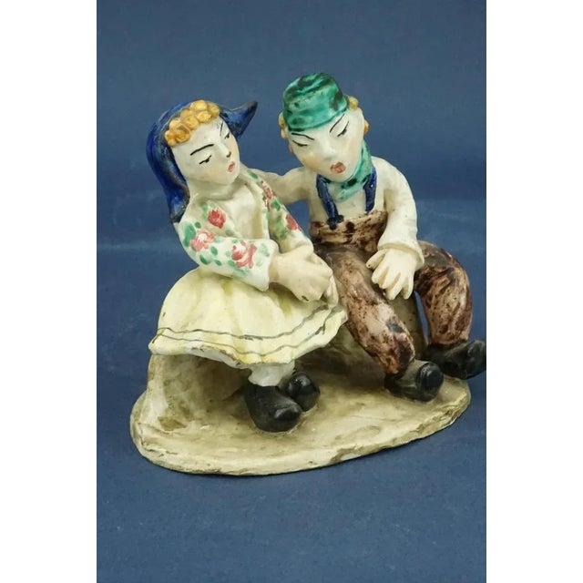 Item description: Hand-modeled and decorated vitrified ceramic sculpture depicting a seated couple, dating back to around...