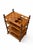 Serving trolley with four pressed wood trays and a turned solid wood frame, probably teak, on four wheels. It shows some...