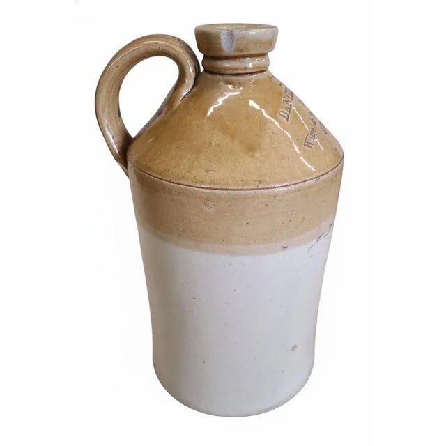 Handsome antique English salt-glazed stoneware spirits jug in classic tan-and-cream two-tone glaze, boldly impressed:...