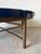 Striking modern coffee table by Donghia featuring a sculptural ribbed bronze base paired with a substantial round blue...