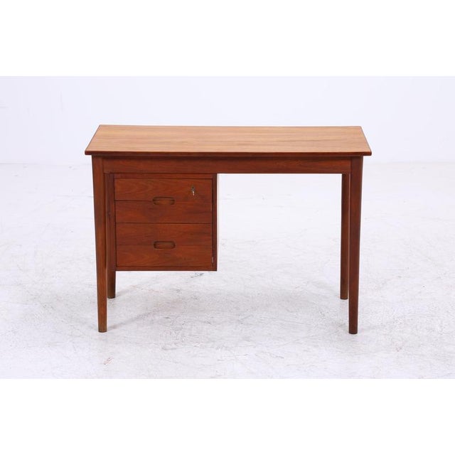Vintage desk in Danish design with beautiful teak grain and clean proportions. Four drawers offer practical storage space...