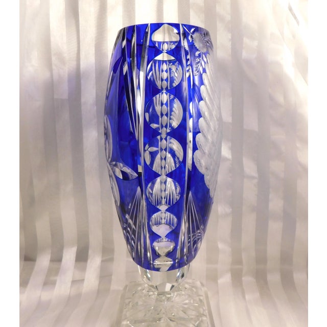This is a very large footed blue cut to clear vase on a clear base. The base is marked as shown and I’m not exactly sure...