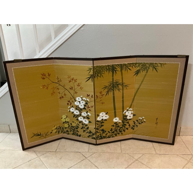 Vintage Japanese four‑panel byōbu screen, hand‑painted with bamboo, chrysanthemums, and autumn foliage on a warm gilt...