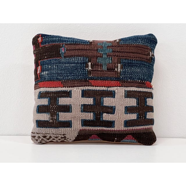 Handcrafted small accent pillow made from a vintage handwoven Turkish kilim, featuring deep indigo, charcoal, ivory,...