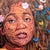 In "Oasis," a striking portrait reveals a figure adorned with a vibrant array of flora and fauna, blending natural...