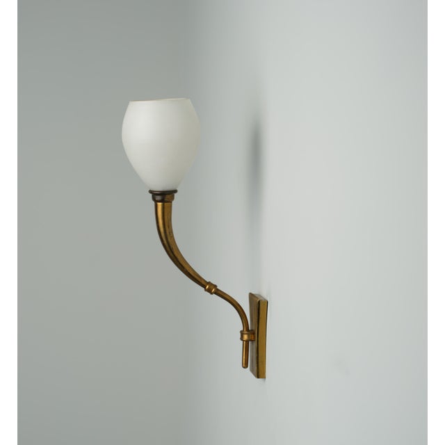 This Italian wall sconce, attributed to Fontana Arte from the 1950s, features a design that marries functionality with...