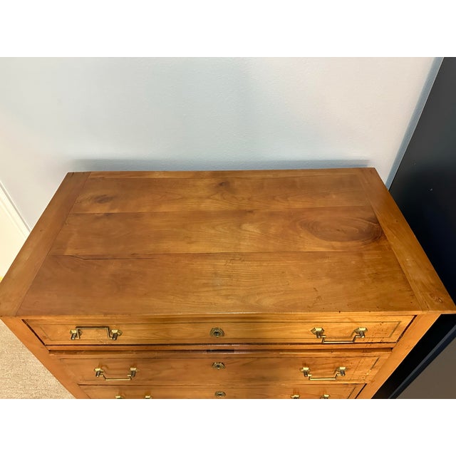 Elegant antique French Louis XVI Revival commode dating to the late 19th century, crafted in beautifully grained fruitwood...