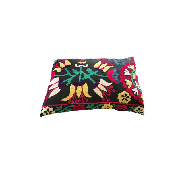 This exquisite custom made pillow features a vintage Uzbek Suzani textile fragment with a black cotton backing, securely...