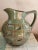 Vintage Denbac studio pottery earthenware pitcher model number 408. It has a moss green/beige finish with a brown and blue...