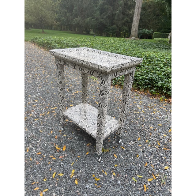 Iconic Karl Springer style python wrapped telephone/cocktail table. Table has two tiers and is finished in polished nickel...