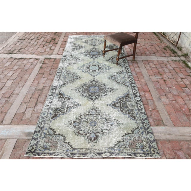 Vintage Turkish Hand-Knotted Distressed Runner Rug is a semi-Vintage rug. '50s Eastern region of Turkey's unique rug is...